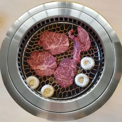 korean bbq marbled beef and mushrooms cooking on saycook db-2017g smokeless grill with stainless steel grilling surface